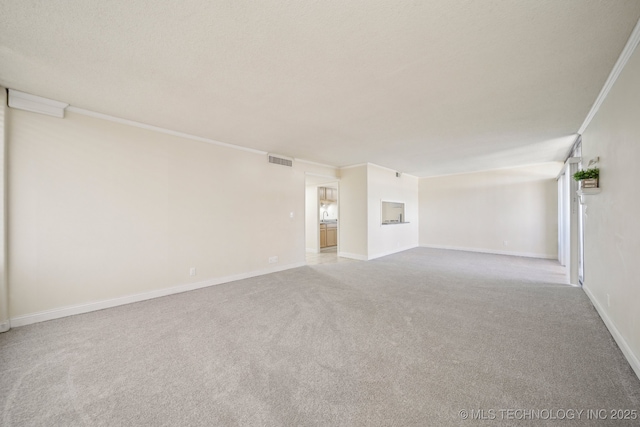 450 W 7th St # 908, Tulsa, OK 74119 - spare room featuring carpet floors and crown molding