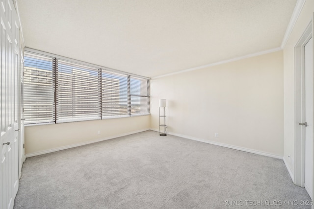 450 W 7th St # 908, Tulsa, OK 74119 - carpeted spare room featuring baseboards and crown molding