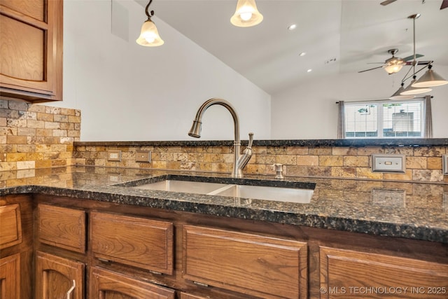 2847 W 115th Pl S, Jenks, OK 74037 - kitchen with lofted ceiling, tasteful backsplash, brown cabinets, decorative light fixtures, and ceiling fan