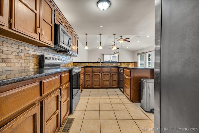 2847 W 115th Pl S, Jenks, OK 74037 - kitchen with appliances with stainless steel finishes, a ceiling fan, lofted ceiling, light tile patterned floors, and decorative backsplash