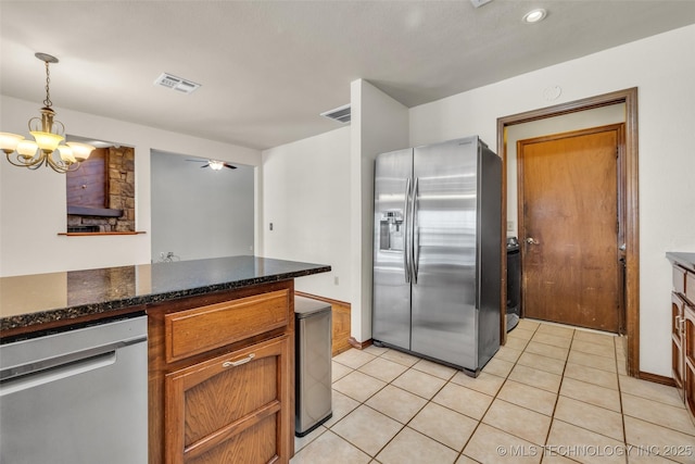 2847 W 115th Pl S, Jenks, OK 74037 - kitchen with stainless steel appliances, light tile patterned floors, hanging light fixtures, ceiling fan, and recessed lighting