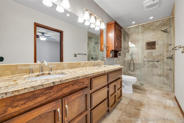 2847 W 115th Pl S, Jenks, OK 74037 - full bathroom featuring double vanity, a stall shower, recessed lighting, a ceiling fan, and stone finish floors
