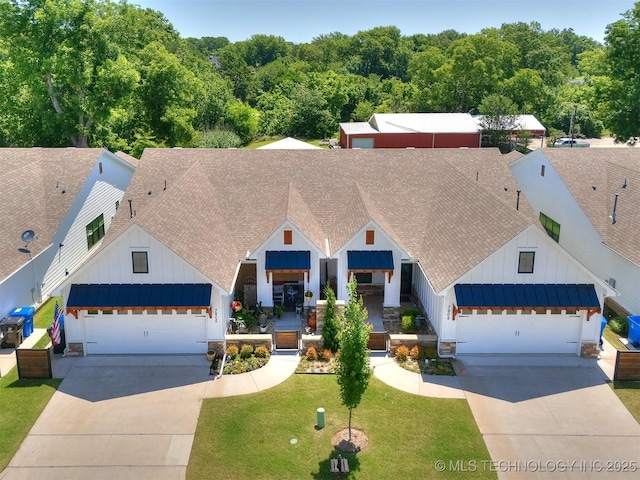 7809 S Redbud Ave, Broken Arrow, OK 74011 - view of front of home featuring board and batten siding, concrete driveway, a garage, and roof with shingles