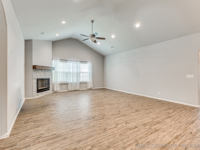 7809 S Redbud Ave, Broken Arrow, OK 74011 - unfurnished living room featuring a ceiling fan, lofted ceiling, light wood-style floors, a stone fireplace, and recessed lighting