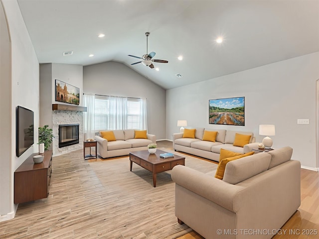 7809 S Redbud Ave, Broken Arrow, OK 74011 - living area featuring lofted ceiling, a ceiling fan, a glass covered fireplace, light wood finished floors, and recessed lighting
