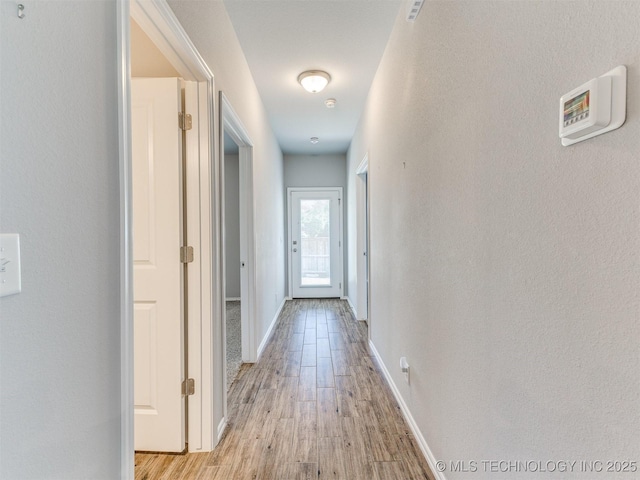 7809 S Redbud Ave, Broken Arrow, OK 74011 - hall featuring light wood-type flooring and baseboards