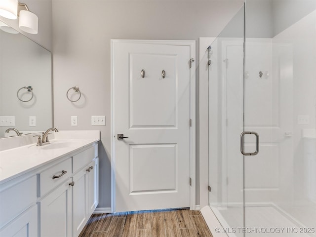 7809 S Redbud Ave, Broken Arrow, OK 74011 - bathroom featuring a stall shower, vanity, and wood finished floors