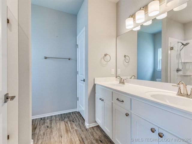 7809 S Redbud Ave, Broken Arrow, OK 74011 - full bathroom featuring a shower stall, wood finished floors, and double vanity