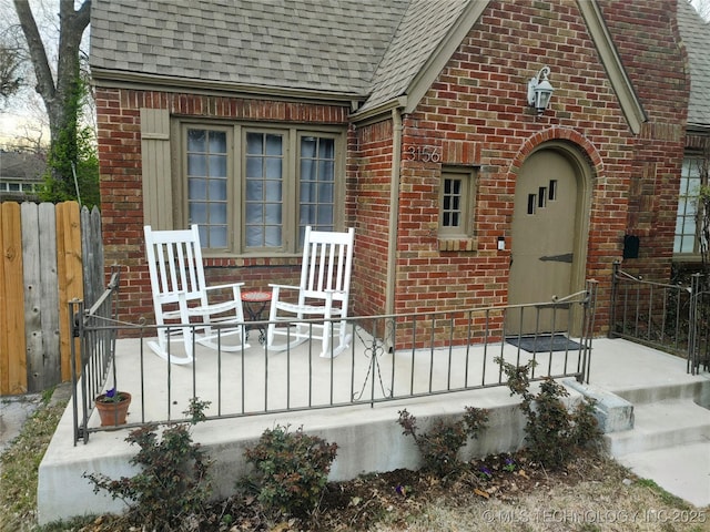 3156 S Madison Ave, Tulsa, OK 74105 - view of exterior entry with a shingled roof and brick siding