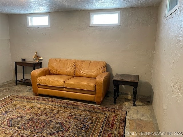 3156 S Madison Ave, Tulsa, OK 74105 - sitting room with stone finish floors, a textured wall, a textured ceiling, and healthy amount of natural light