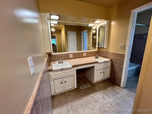 3707 Canton Ave, Tulsa, OK 74135 - bathroom featuring double vanity, tile patterned flooring, and tile walls