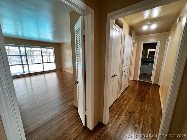 3707 Canton Ave, Tulsa, OK 74135 - hallway with dark wood-style floors and baseboards