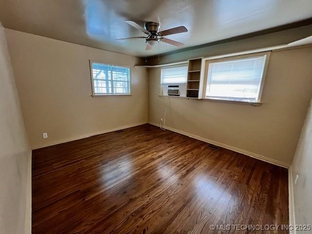 3707 Canton Ave, Tulsa, OK 74135 - unfurnished room featuring a ceiling fan, dark wood finished floors, and cooling unit