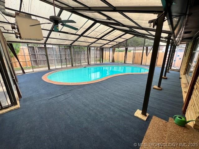3707 Canton Ave, Tulsa, OK 74135 - indoor pool with a fenced backyard, glass enclosure, and a patio area