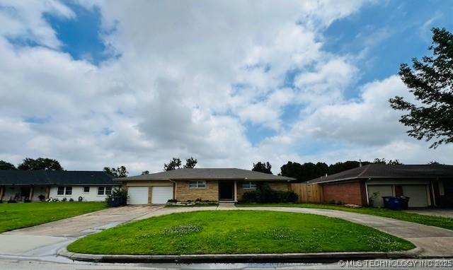 3707 Canton Ave, Tulsa, OK 74135 - ranch-style house featuring concrete driveway, a garage, and a front yard