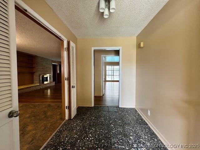 3707 Canton Ave, Tulsa, OK 74135 - hallway featuring a textured ceiling and baseboards