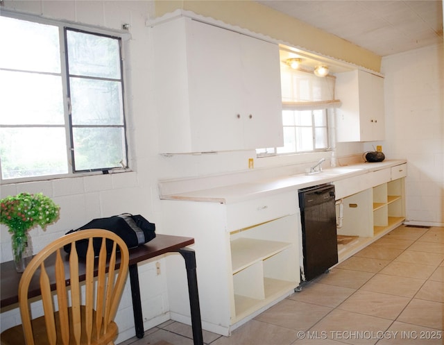 3812 E 28th St, Tulsa, OK 74114 - kitchen featuring open shelves, white cabinets, black dishwasher, light tile patterned floors, and light countertops