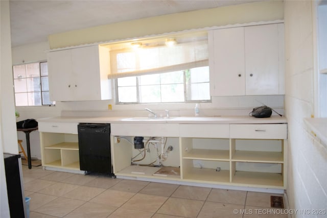 3812 E 28th St, Tulsa, OK 74114 - kitchen featuring black dishwasher, open shelves, white cabinetry, light countertops, and light tile patterned floors