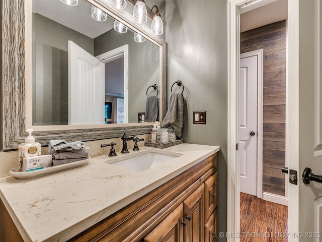 7001 S Redbud Ave, Broken Arrow, OK 74011 - bathroom with vanity, wood finished floors, and wood walls