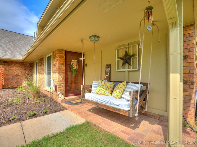 7001 S Redbud Ave, Broken Arrow, OK 74011 - view of exterior entry with brick siding and roof with shingles