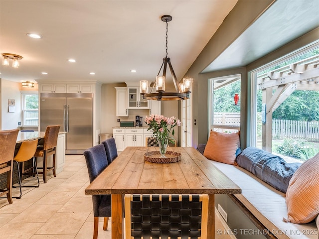 7001 S Redbud Ave, Broken Arrow, OK 74011 - dining room with healthy amount of natural light, light tile patterned floors, a chandelier, and recessed lighting