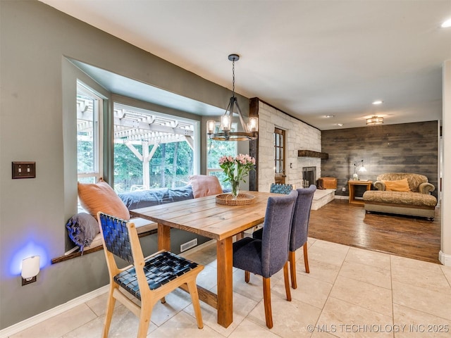7001 S Redbud Ave, Broken Arrow, OK 74011 - dining space featuring light tile patterned floors, a stone fireplace, a chandelier, and recessed lighting