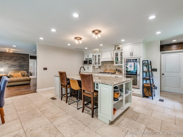 7001 S Redbud Ave, Broken Arrow, OK 74011 - kitchen featuring appliances with stainless steel finishes, premium range hood, open shelves, recessed lighting, and decorative backsplash