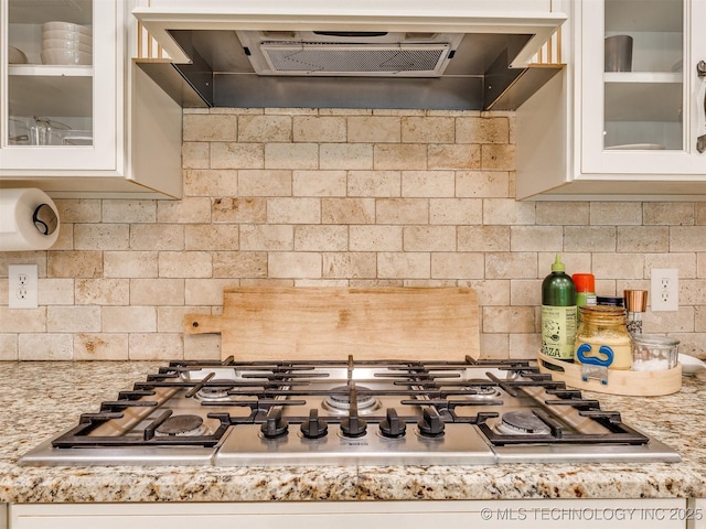 7001 S Redbud Ave, Broken Arrow, OK 74011 - kitchen featuring range hood, stainless steel gas cooktop, backsplash, and white cabinetry