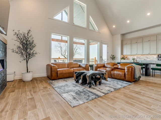 409340 E 1190th Rd, Eufaula, OK 74432 - living area with high vaulted ceiling, a fireplace, light wood-style flooring, and recessed lighting