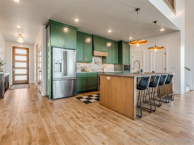 409340 E 1190th Rd, Eufaula, OK 74432 - kitchen with stainless steel appliances, green cabinetry, light wood-type flooring, tasteful backsplash, and recessed lighting