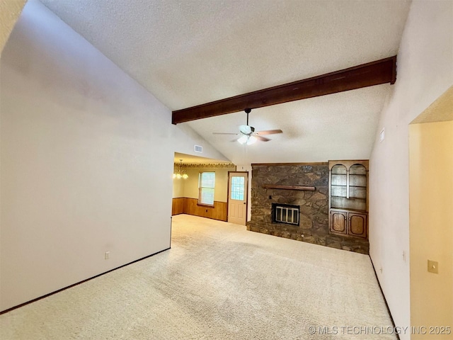 9613 N 107th E Ave, Owasso, OK 74055 - unfurnished living room featuring a ceiling fan, carpet floors, a textured ceiling, and a stone fireplace