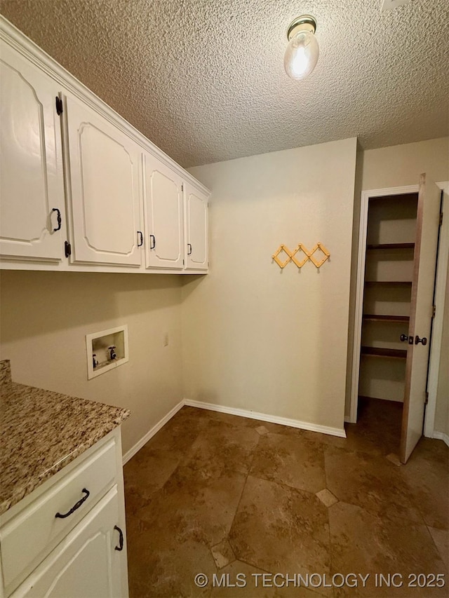 9613 N 107th E Ave, Owasso, OK 74055 - laundry room with cabinet space, hookup for a washing machine, and a textured ceiling