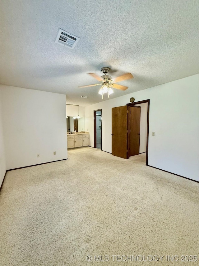9613 N 107th E Ave, Owasso, OK 74055 - unfurnished living room with ceiling fan, carpet floors, and a textured ceiling