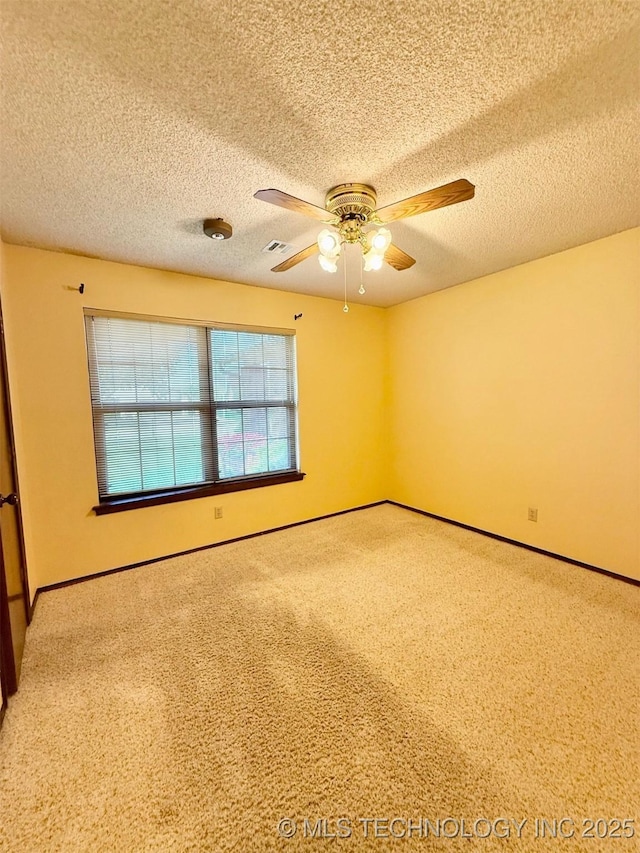 9613 N 107th E Ave, Owasso, OK 74055 - carpeted spare room with ceiling fan and a textured ceiling