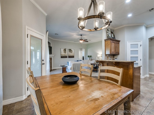 2603 S 16th Pl, Broken Arrow, OK 74012 - dining room with a ceiling fan, a chandelier, ornamental molding, a tiled fireplace, and light stone finish flooring
