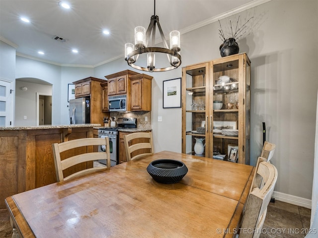 2603 S 16th Pl, Broken Arrow, OK 74012 - dining area featuring a chandelier, arched walkways, crown molding, and recessed lighting