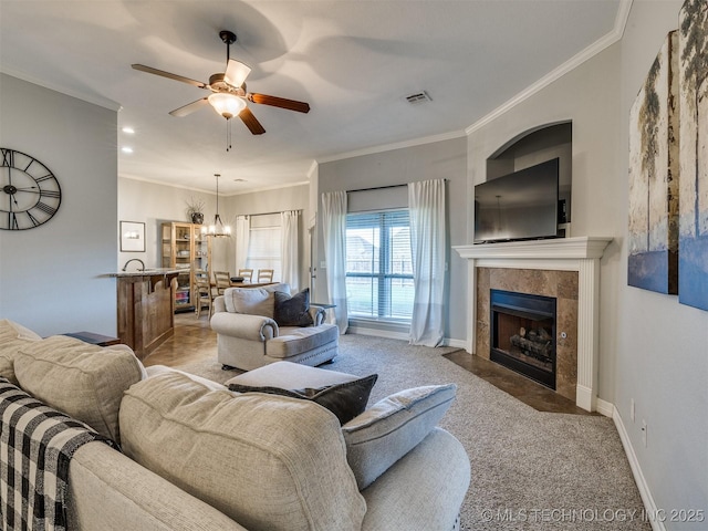 2603 S 16th Pl, Broken Arrow, OK 74012 - living area featuring a tile fireplace, a ceiling fan, ornamental molding, light carpet, and recessed lighting