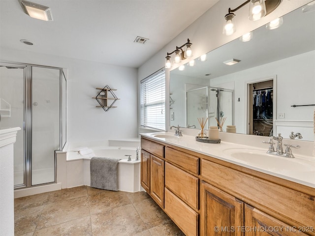 2603 S 16th Pl, Broken Arrow, OK 74012 - bathroom featuring a stall shower, double vanity, a garden tub, and a spacious closet