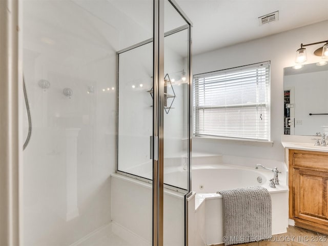 2603 S 16th Pl, Broken Arrow, OK 74012 - bathroom featuring vanity, a shower stall, and a jetted tub