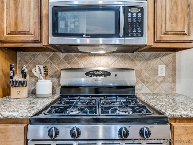 2603 S 16th Pl, Broken Arrow, OK 74012 - kitchen featuring appliances with stainless steel finishes, brown cabinetry, and tasteful backsplash