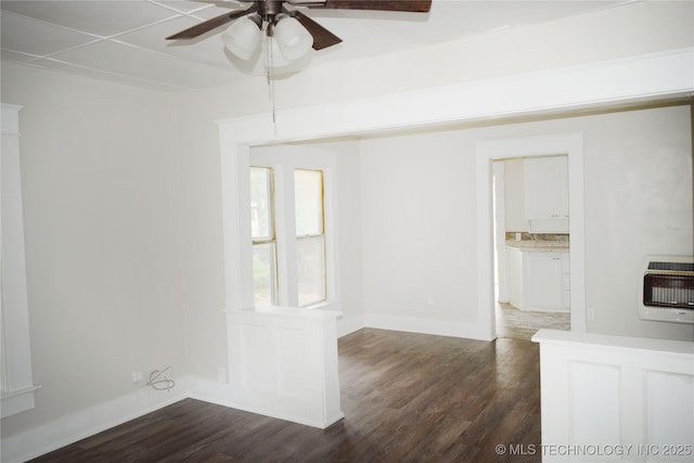 602 N Taft Ave, Okmulgee, OK 74447 - empty room with heating unit, ceiling fan, and dark wood-style floors