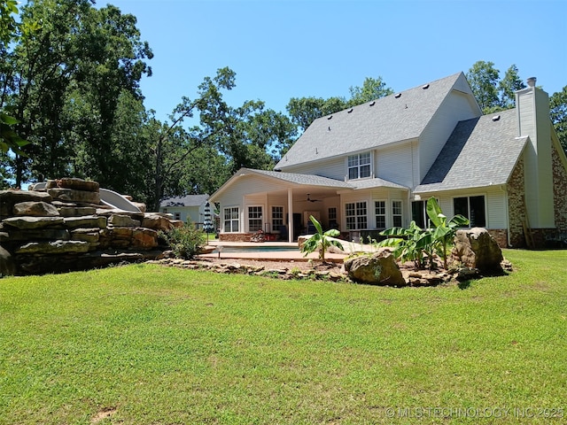 501 W 35th Pl, Sand Springs, OK 74063 - rear view of property featuring ceiling fan, a patio, a yard, a shingled roof, and a chimney
