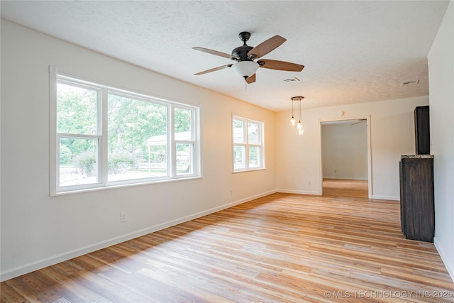 11598 E Oak St, Claremore, OK 74019 - unfurnished room with light wood-style flooring, a ceiling fan, and a textured ceiling