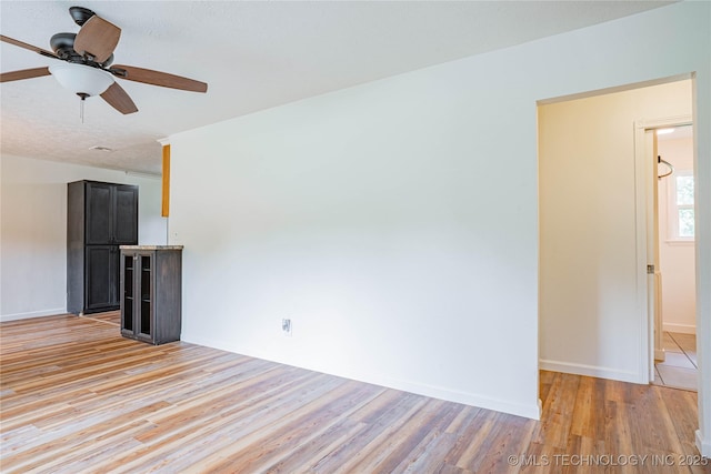 11598 E Oak St, Claremore, OK 74019 - unfurnished living room featuring light wood-type flooring and a ceiling fan