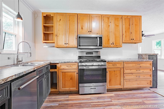 11598 E Oak St, Claremore, OK 74019 - kitchen with stainless steel appliances, open shelves, light wood finished floors, tasteful backsplash, and ceiling fan