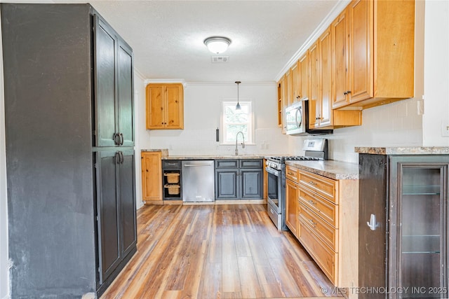 11598 E Oak St, Claremore, OK 74019 - kitchen with appliances with stainless steel finishes, light wood-type flooring, tasteful backsplash, ornamental molding, and pendant lighting