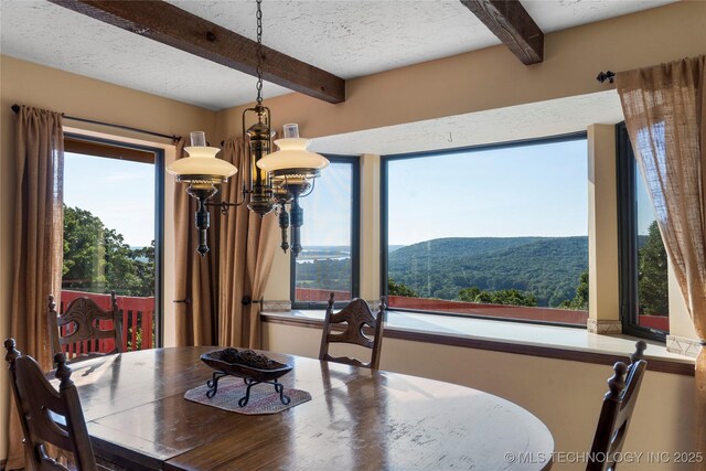 17304 E 176th St S, Bixby, OK 74008 - dining room featuring beam ceiling, a chandelier, a textured ceiling, and a mountain view
