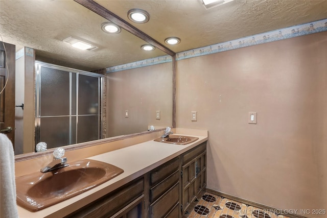17304 E 176th St S, Bixby, OK 74008 - full bathroom featuring recessed lighting, a textured ceiling, double vanity, and a shower stall