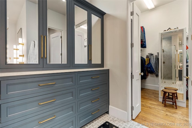 2524 E 66th Pl, Tulsa, OK 74136 - bathroom featuring wood finished floors and an enclosed shower