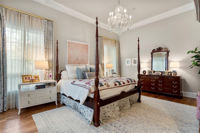 2524 E 66th Pl, Tulsa, OK 74136 - bedroom featuring multiple windows, a chandelier, ornamental molding, and wood finished floors